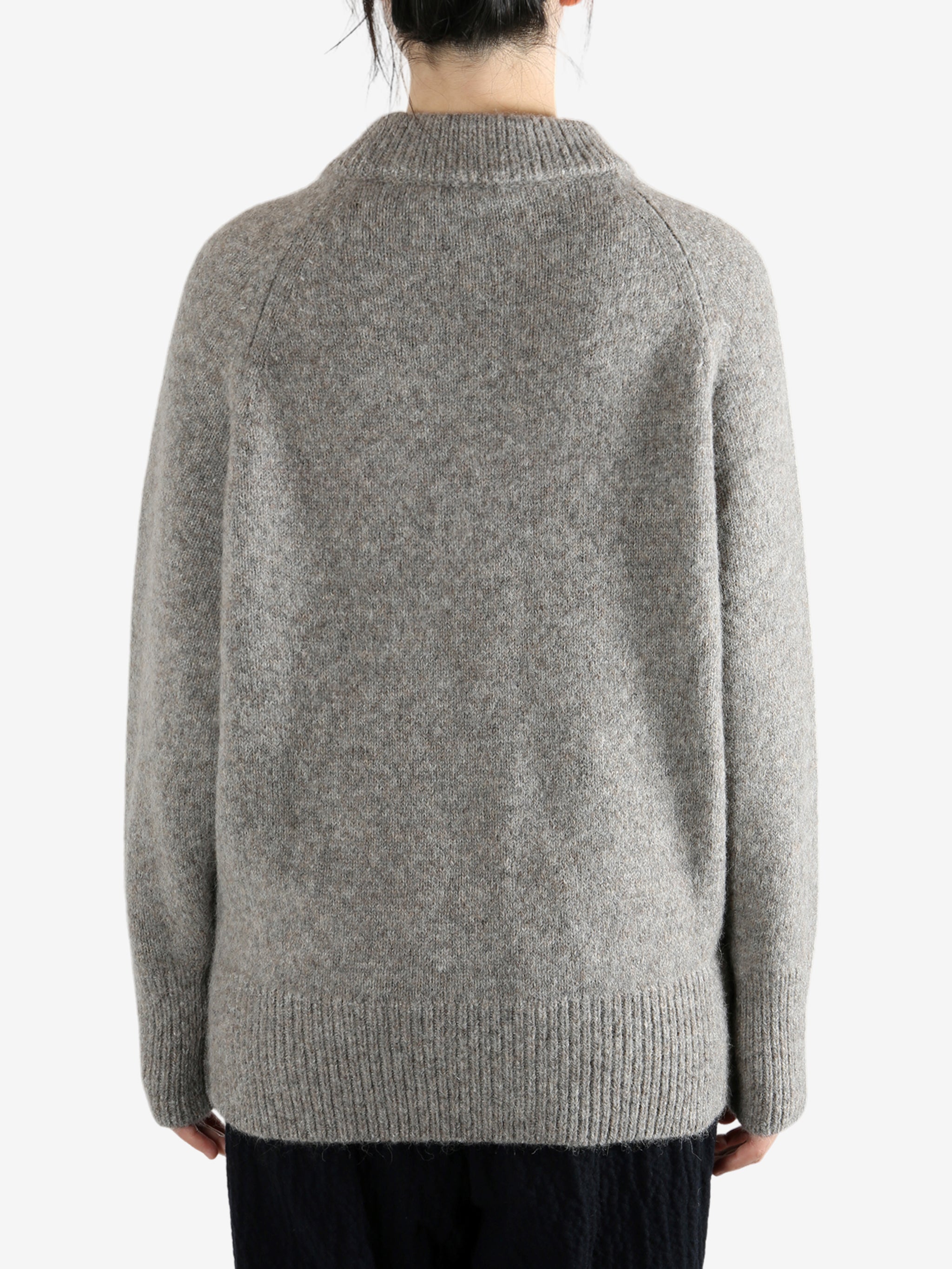 Grey sweater worn by a person, showing the sweater fit