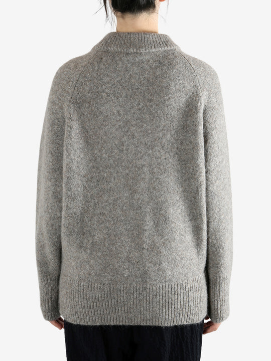 Grey sweater worn by a person, showing the sweater fit