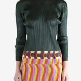 green ribbed sweater worn by a person, showing the sweater fit