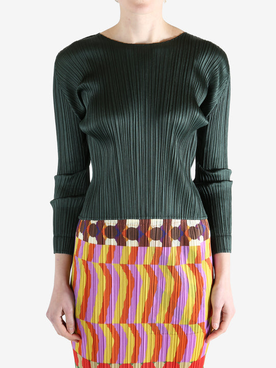 green ribbed sweater worn by a person, showing the sweater fit