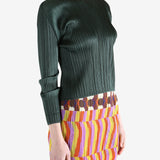 green ribbed sweater worn by a person, showing the sweater fit