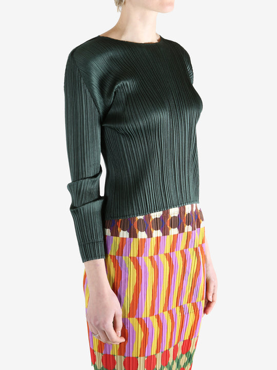 green ribbed sweater worn by a person, showing the sweater fit