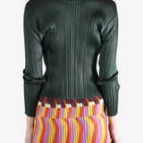 green ribbed sweater worn by a person, showing the sweater fit