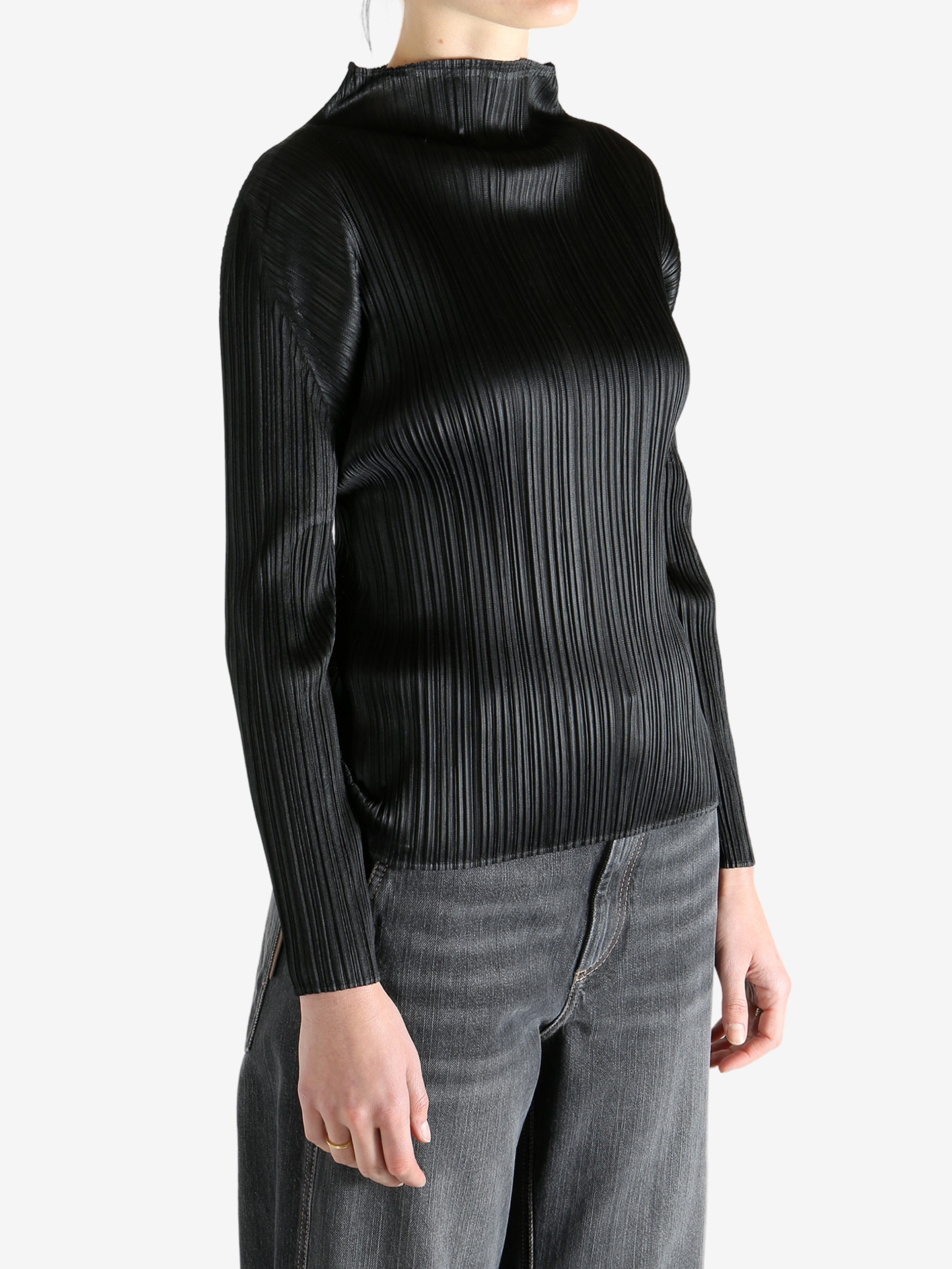 Black shirt worn by a person, showing the shirt's fit