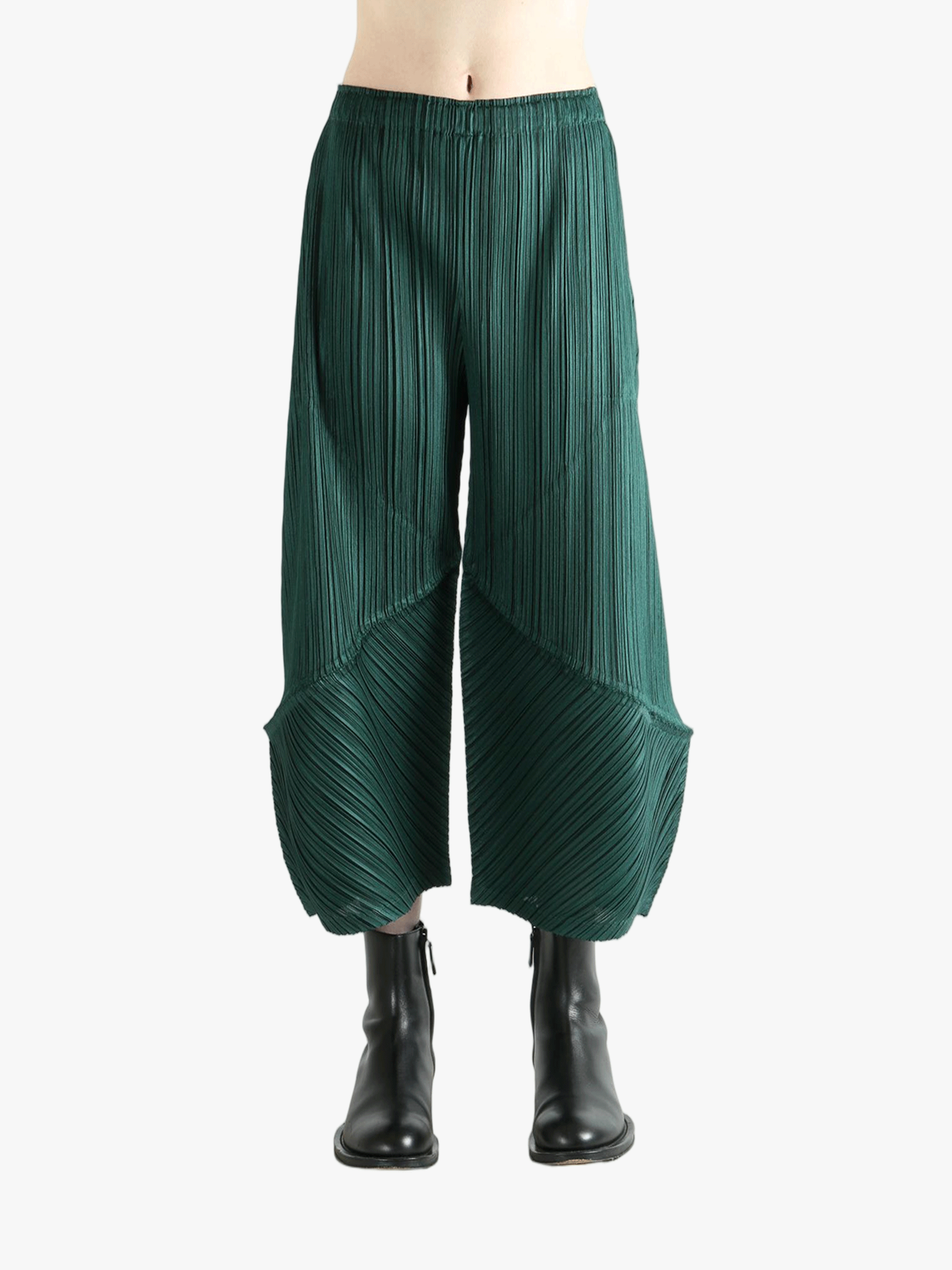 Green pants worn by a person, showing the pants's fit