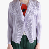 Purple knitwear worn by a person, showing the knitwear fit