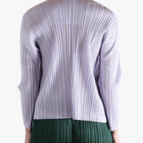 Purple knitwear worn by a person, showing the knitwear fit
