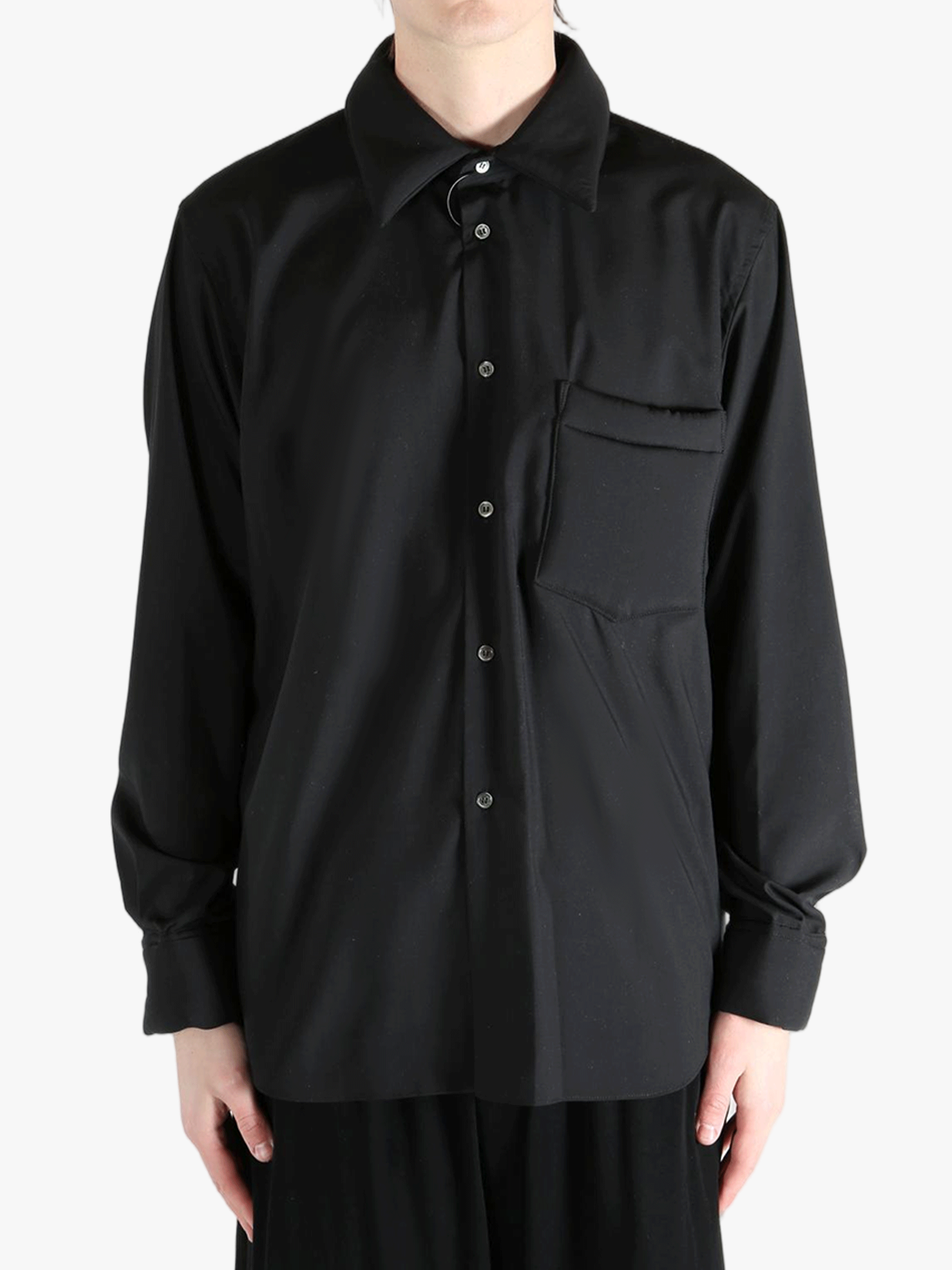 Black shirt worn by a person, showing the shirt's fit