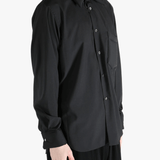 Black shirt worn by a person, showing the shirt's fit