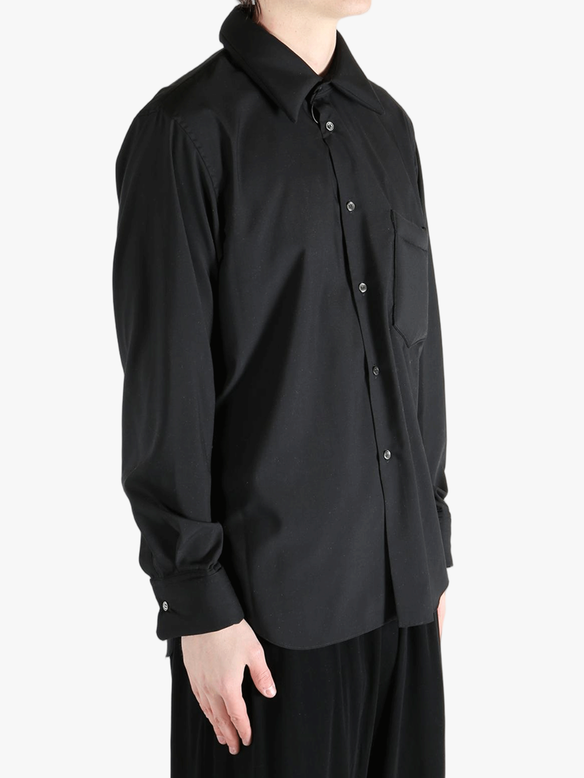 Black shirt worn by a person, showing the shirt's fit