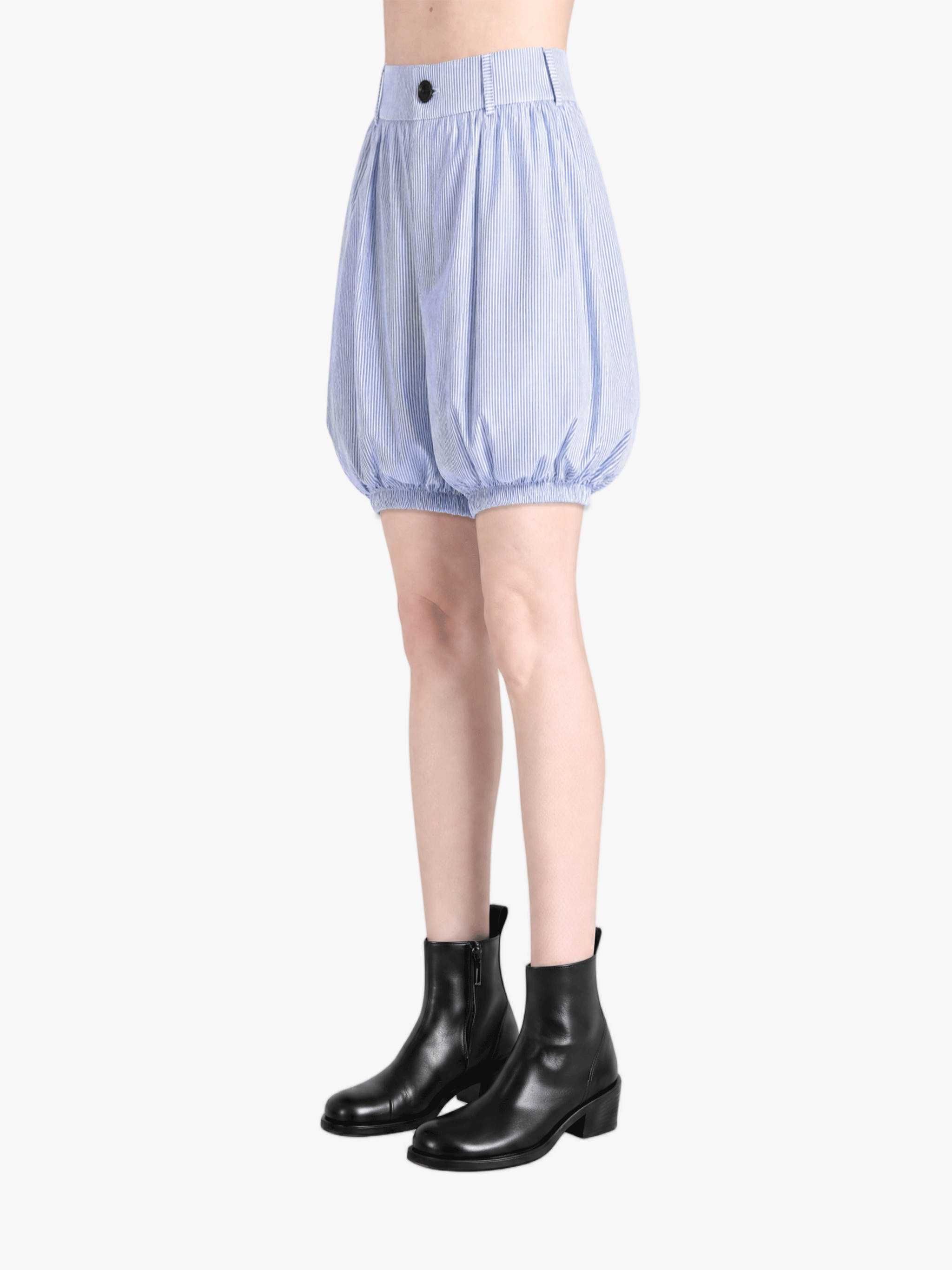 Blue shorts worn by a person, side view