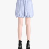 Blue shorts worn by a person, back view