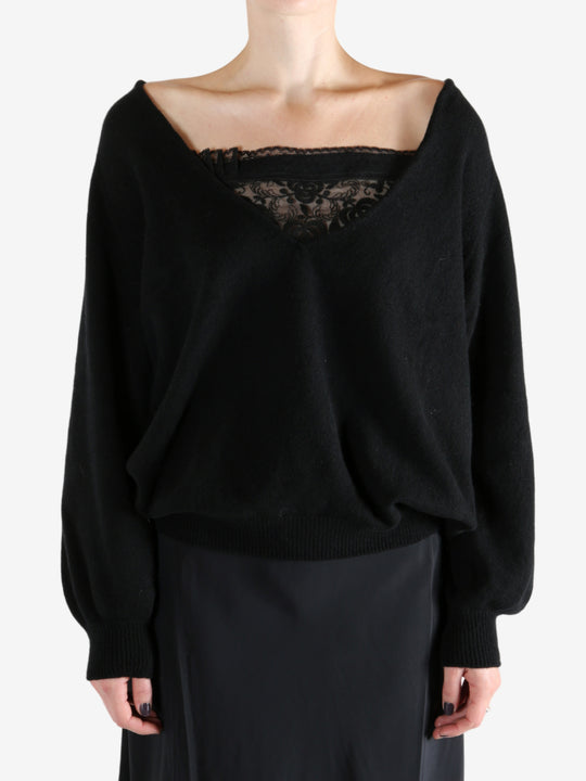 Black sweatshirt worn by a person, showing the sweatshirt fit