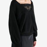 Black sweatshirt worn by a person, showing the sweatshirt fit