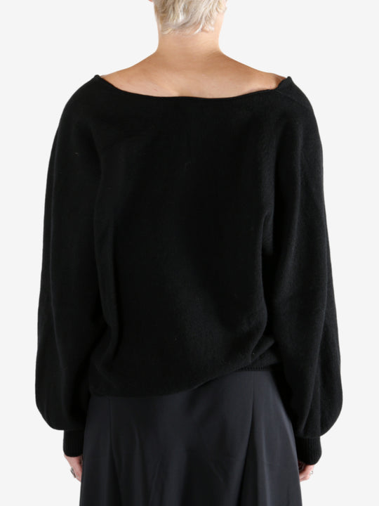 Black sweatshirt worn by a person, showing the sweatshirt fit