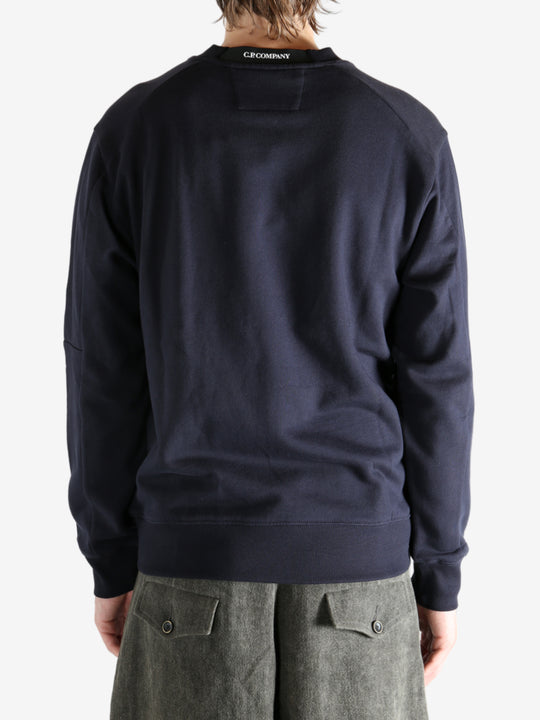 Blue sweatshirt worn by a person, showing the sweats' fit