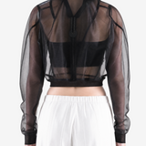 Black jacket worn by a person, back view
