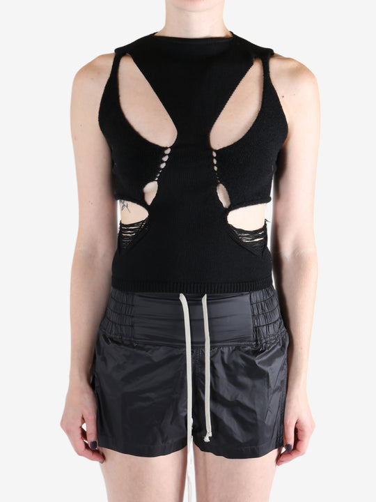 Black top worn by a person, showing the tops's fit