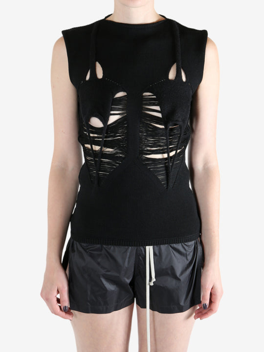 Black top worn by a person, showing the top's fit