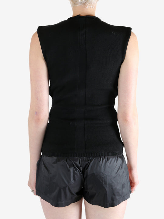 Black top worn by a person, showing the top's fit