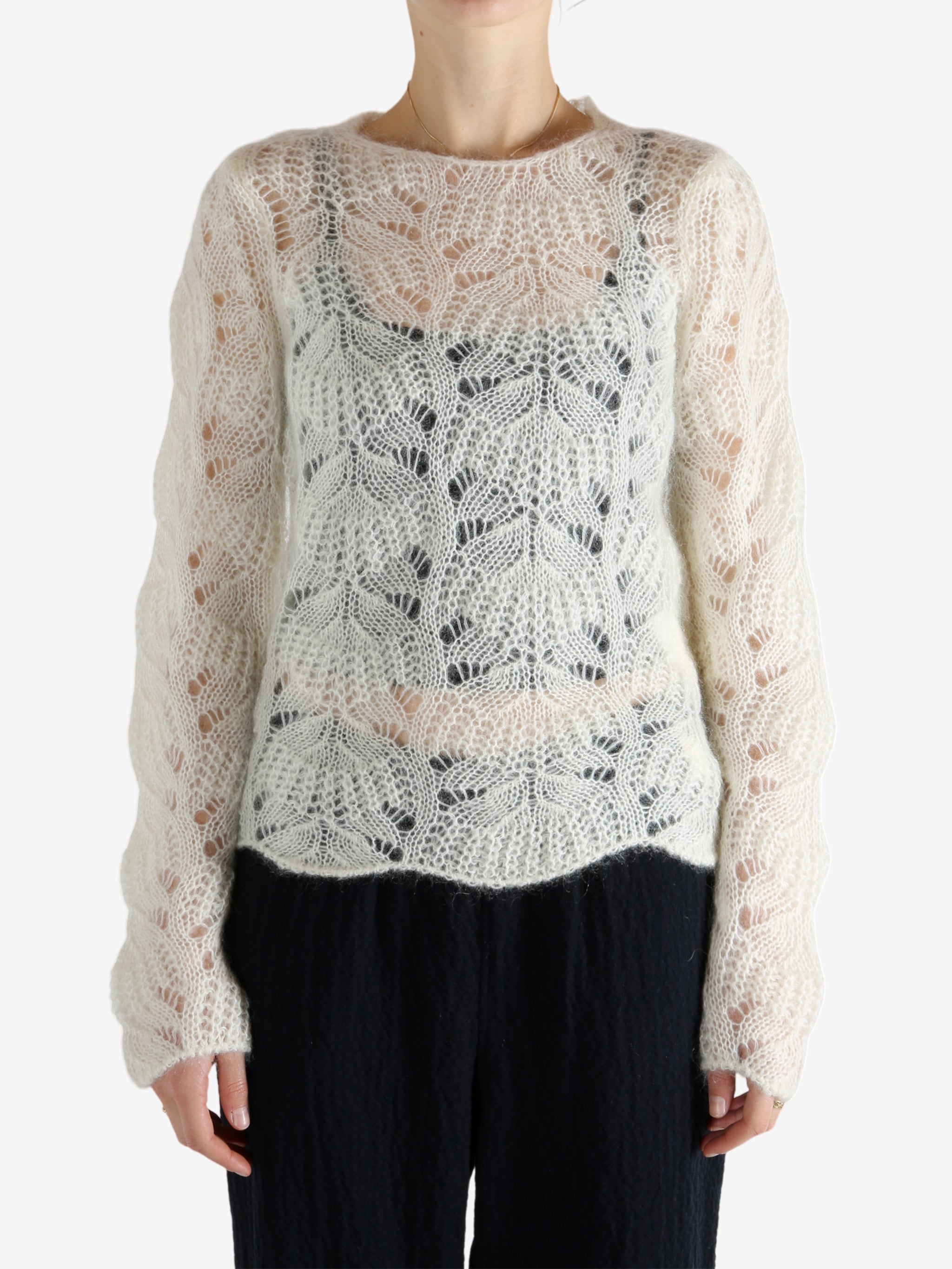 White sweater worn by a person, showing the sweater's fit