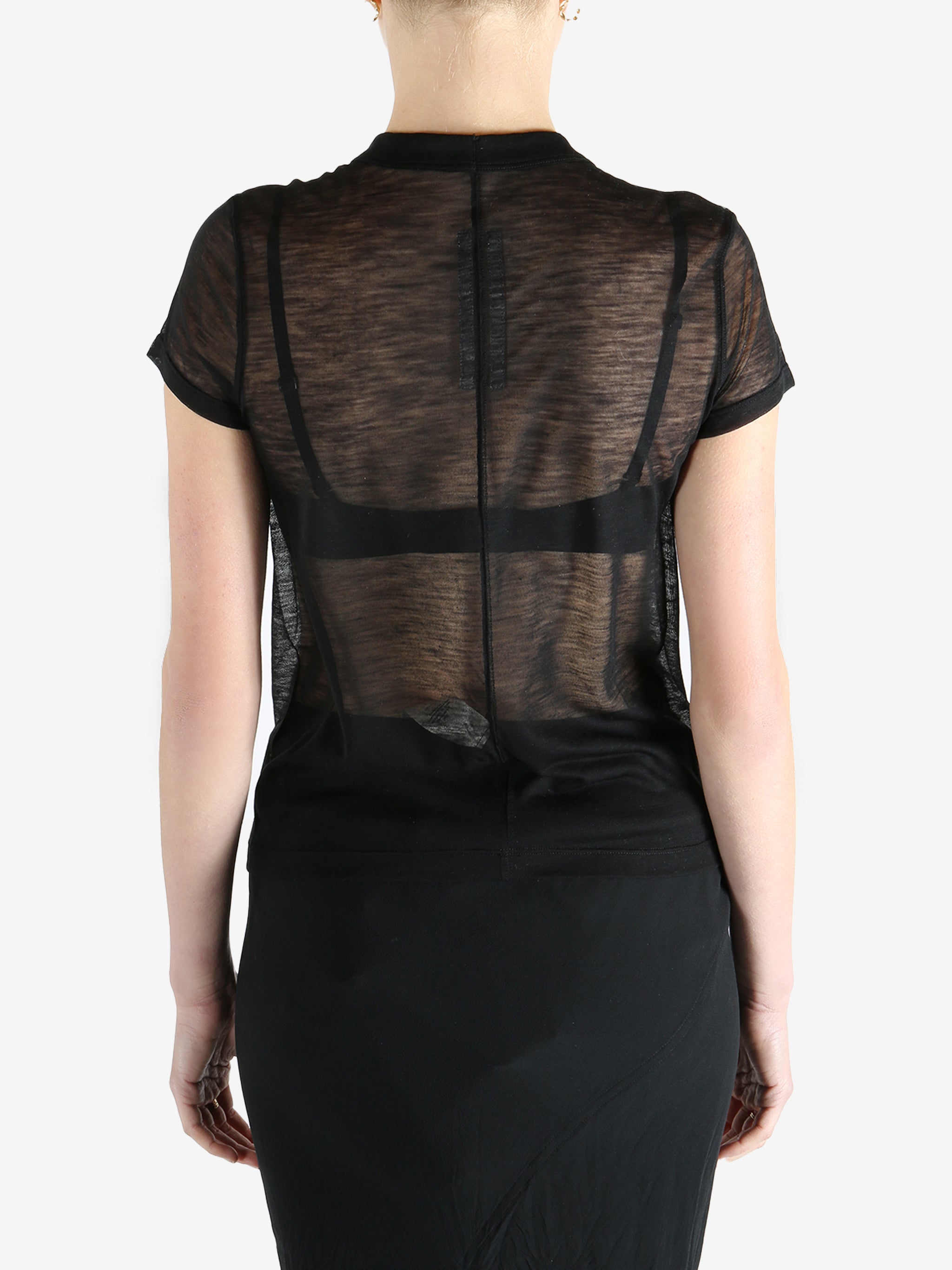 Black t-shirt worn by a person, showing the shirt's fit