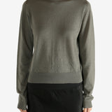 Grey knitwear worn by a person,showing the knitwear's fit