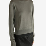 Grey knitwear worn by a person,showing the knitwear's fit