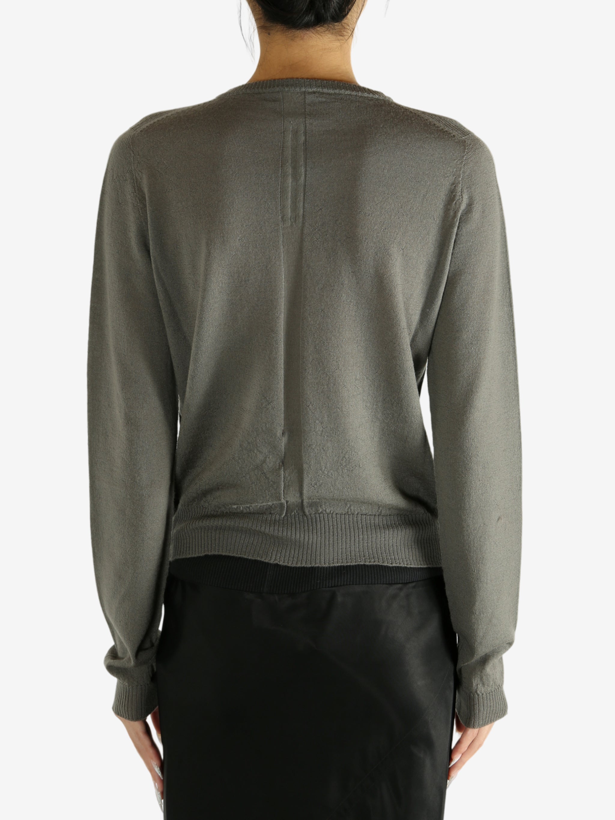 Grey knitwear worn by a person,showing the knitwear's fit