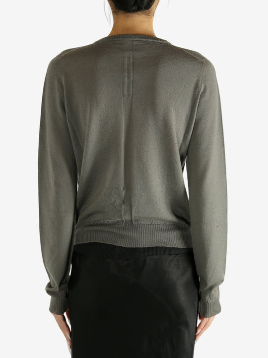 Grey knitwear worn by a person,showing the knitwear's fit