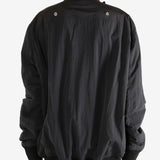 Black jacket worn by a person,showing the jacket's fit