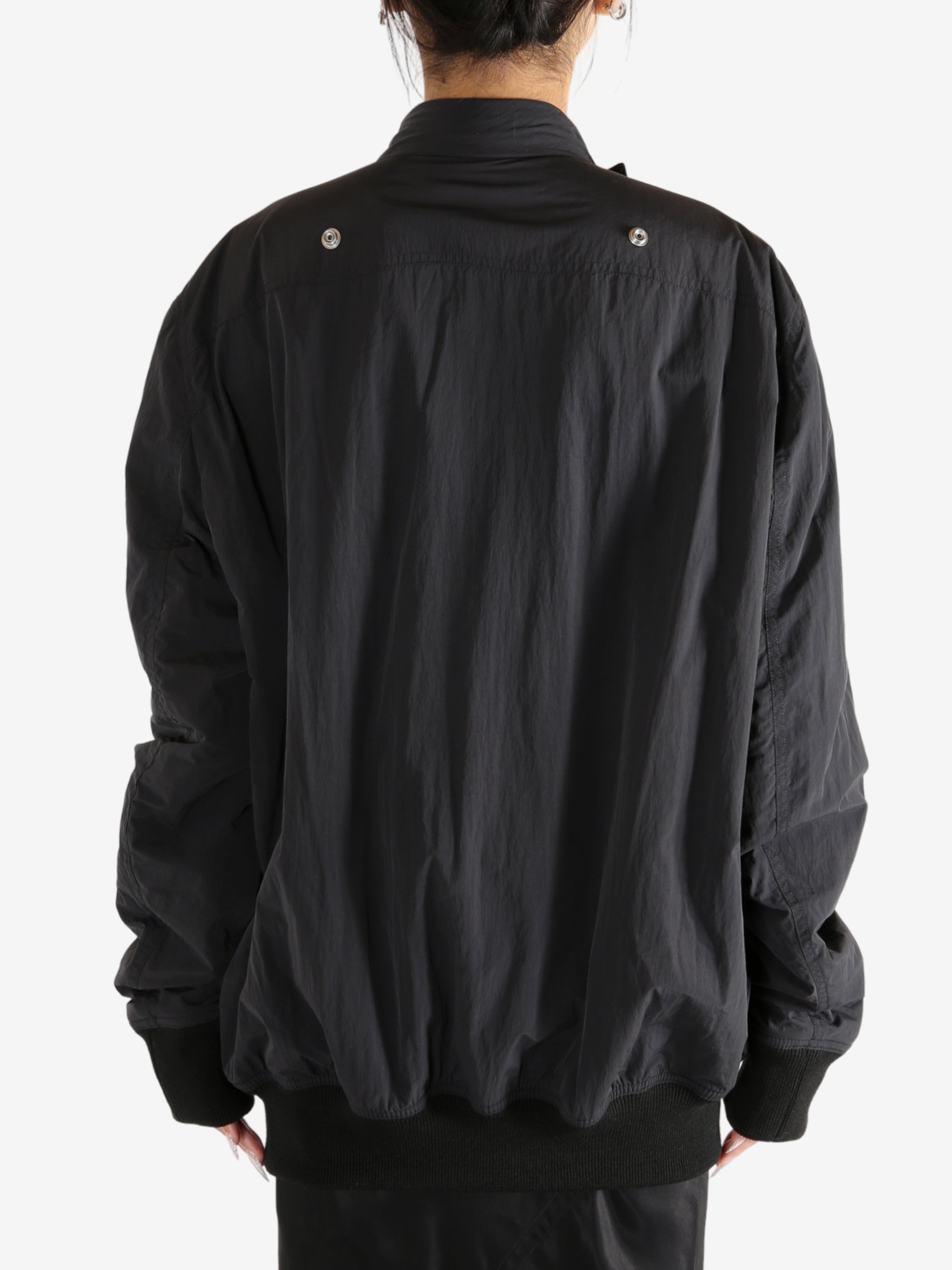 Black jacket worn by a person,showing the jacket's fit