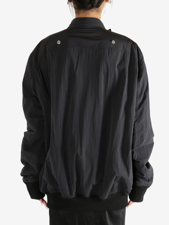 Black jacket worn by a person,showing the jacket's fit