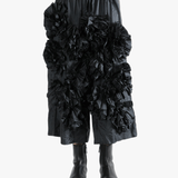 Black pant  worn by a person, showing the pant 's fit