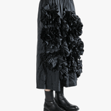 Black pant  worn by a person, showing the pant 's fit