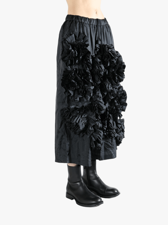 Black pant  worn by a person, showing the pant 's fit