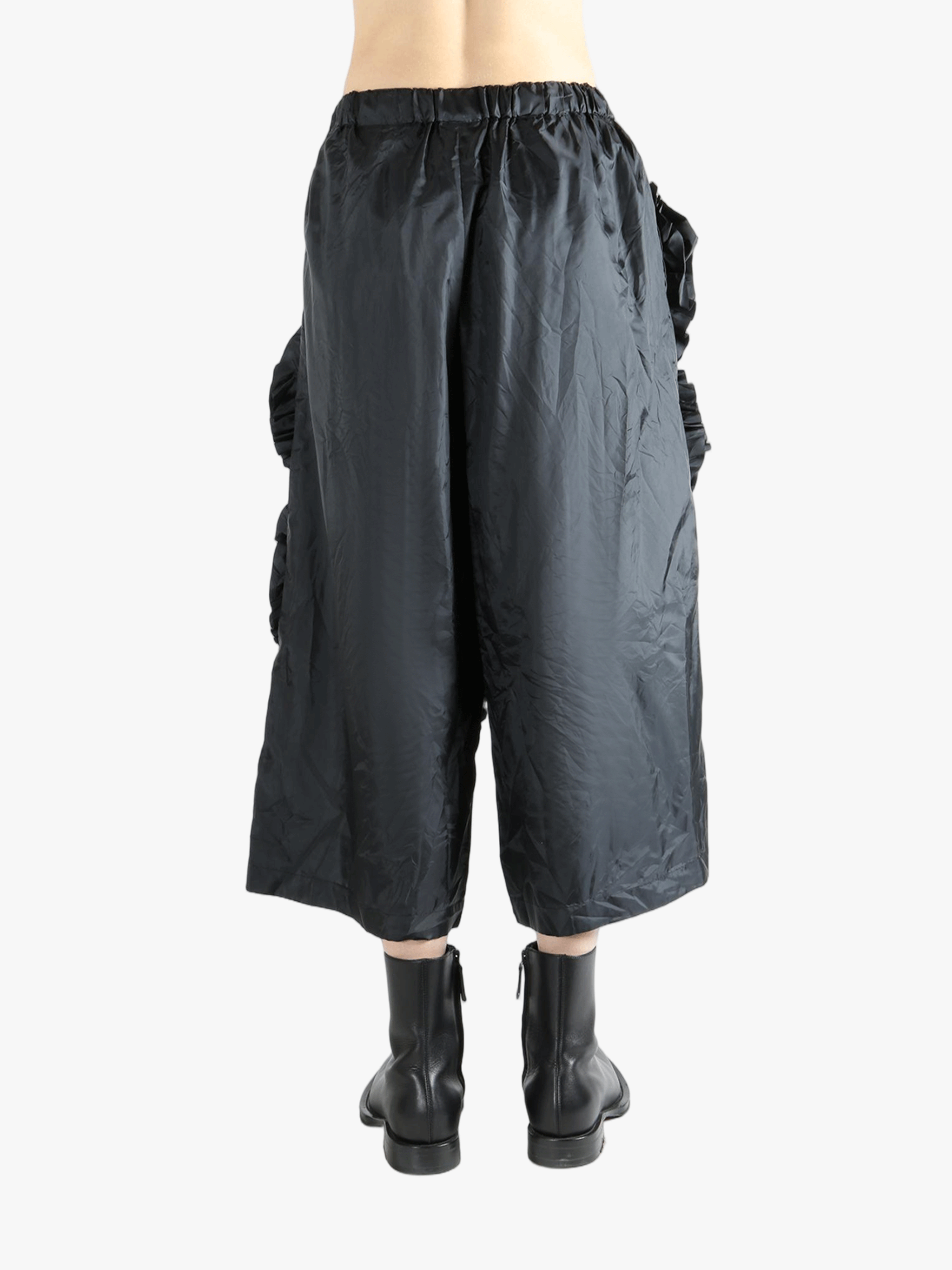 Black pant  worn by a person, showing the pant 's fit