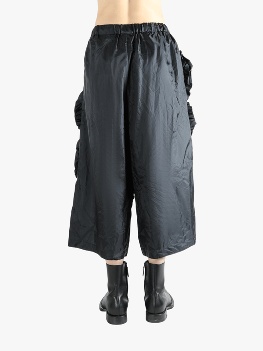 Black pant  worn by a person, showing the pant 's fit