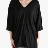 Black shirt worn by a person, showing the  shirt fit