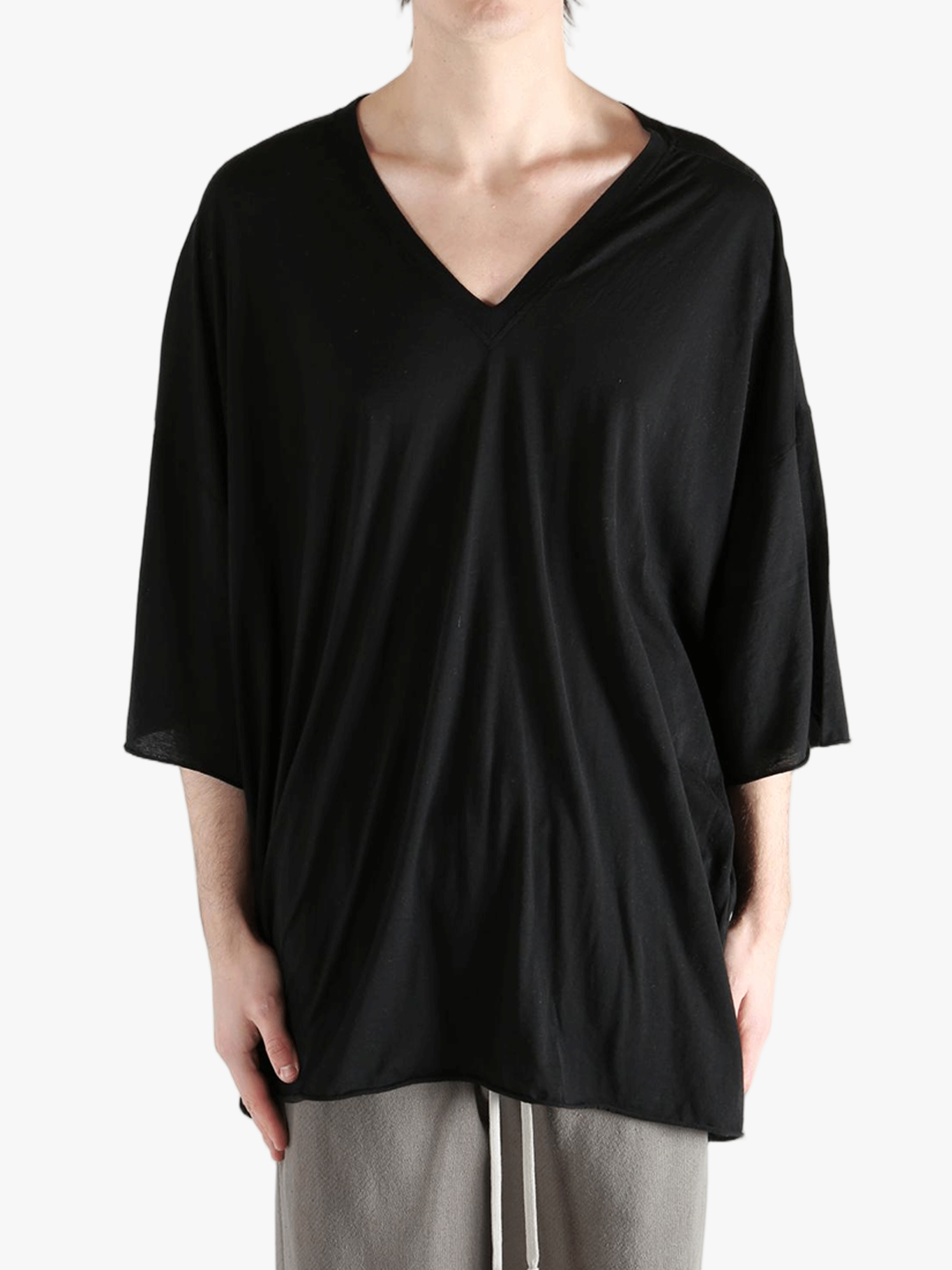 Black shirt worn by a person, showing the  shirt fit