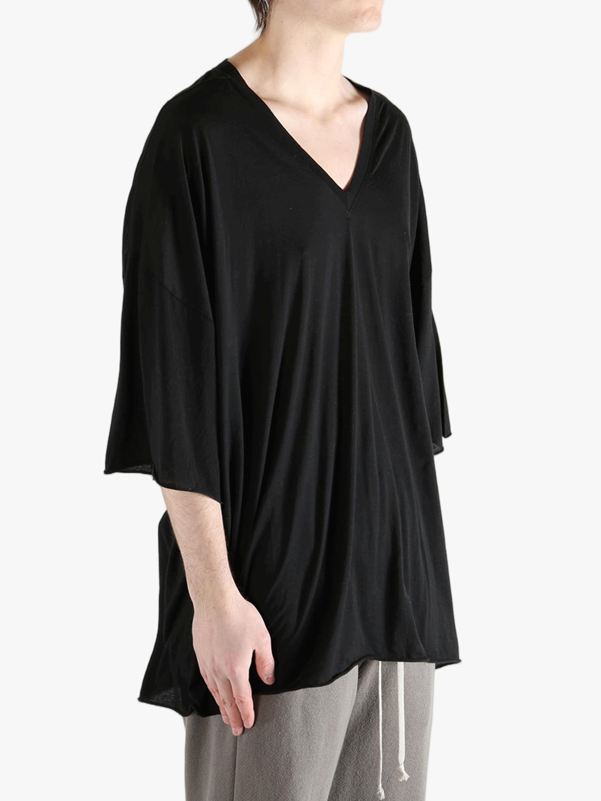 Black shirt worn by a person, showing the  shirt fit