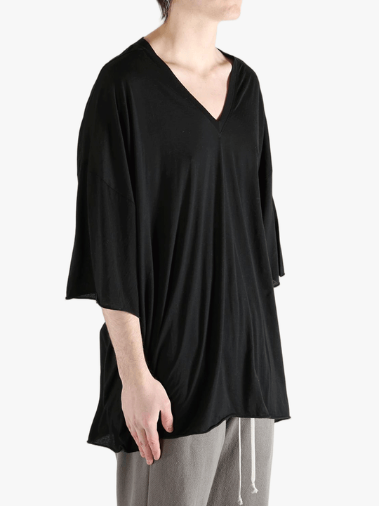 Black shirt worn by a person, showing the  shirt fit