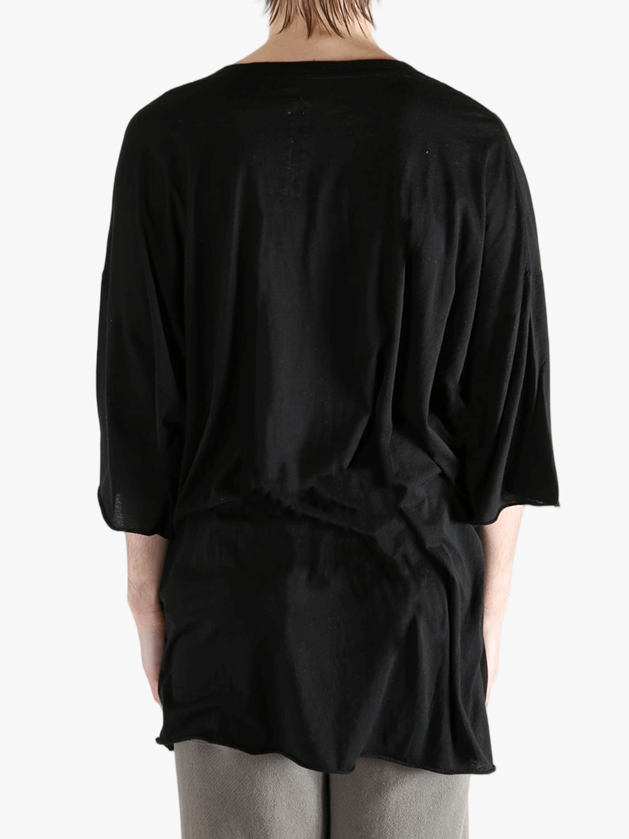 Black shirt worn by a person, showing the  shirt fit