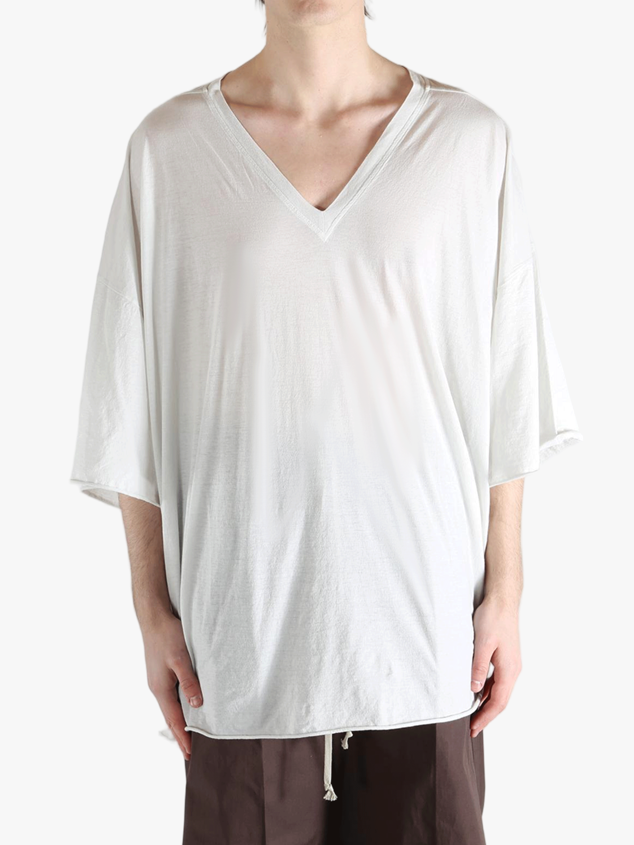 White t-shirt worn by a person, showing the shirt's fit