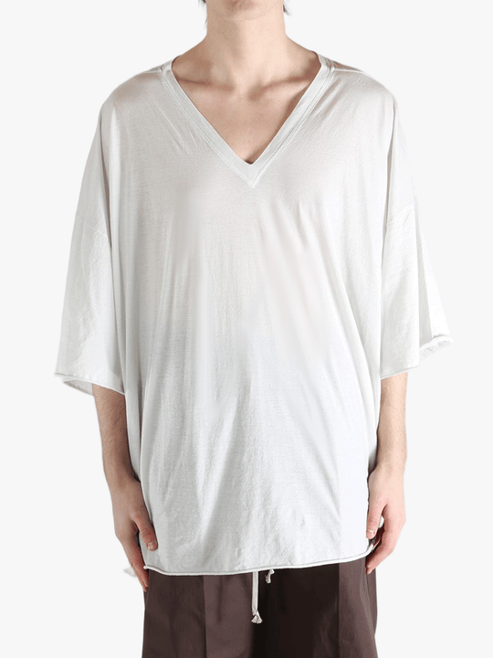 White t-shirt worn by a person, showing the shirt's fit