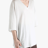 White t-shirt worn by a person, showing the shirt's fit