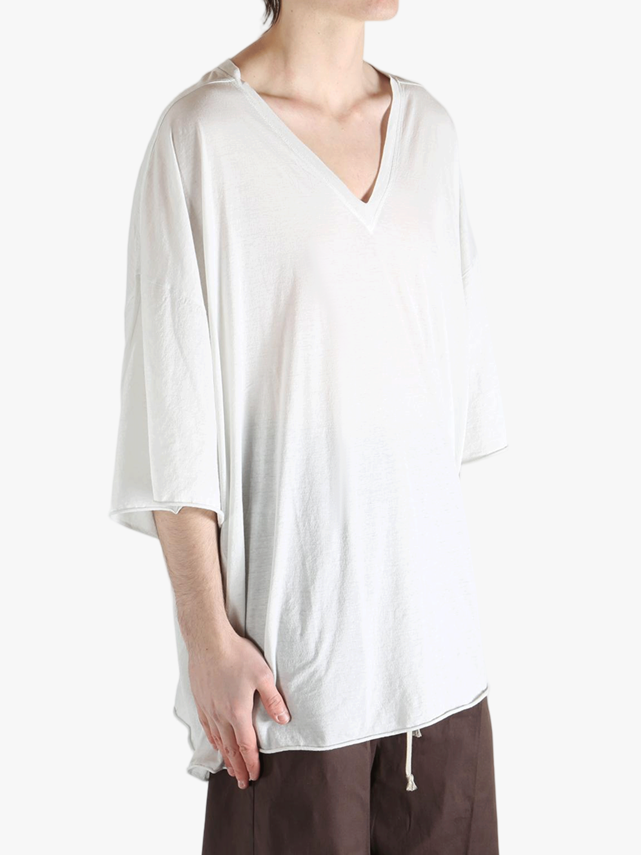 White t-shirt worn by a person, showing the shirt's fit