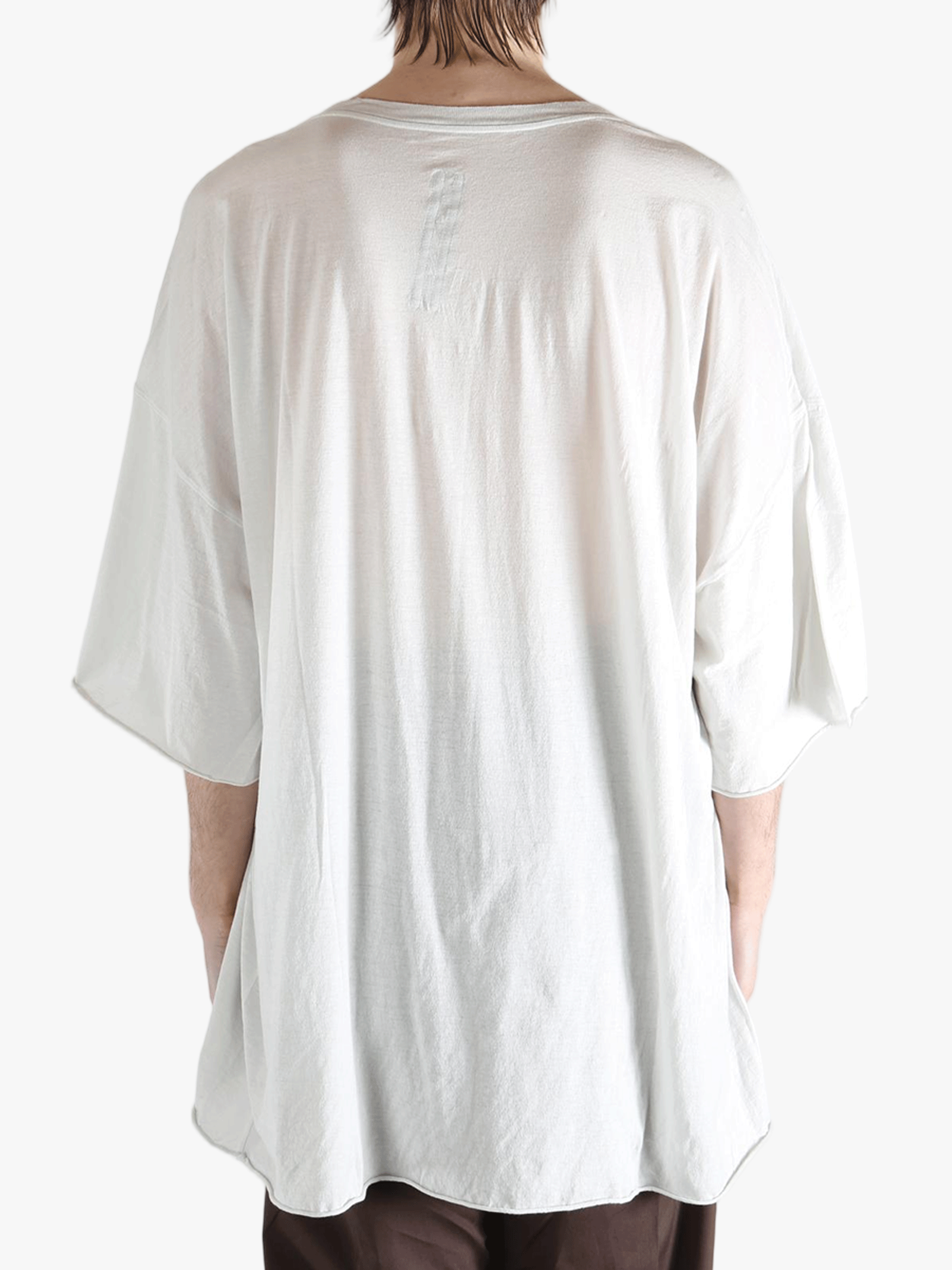 White t-shirt worn by a person, showing the shirt's fit