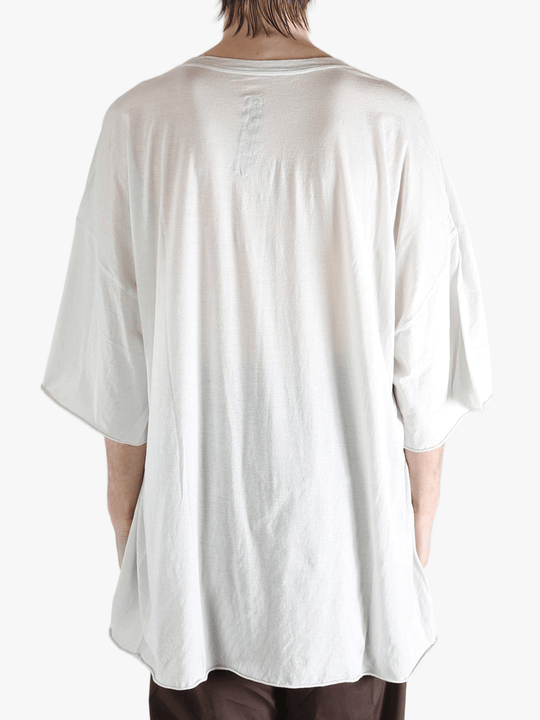 White t-shirt worn by a person, showing the shirt's fit