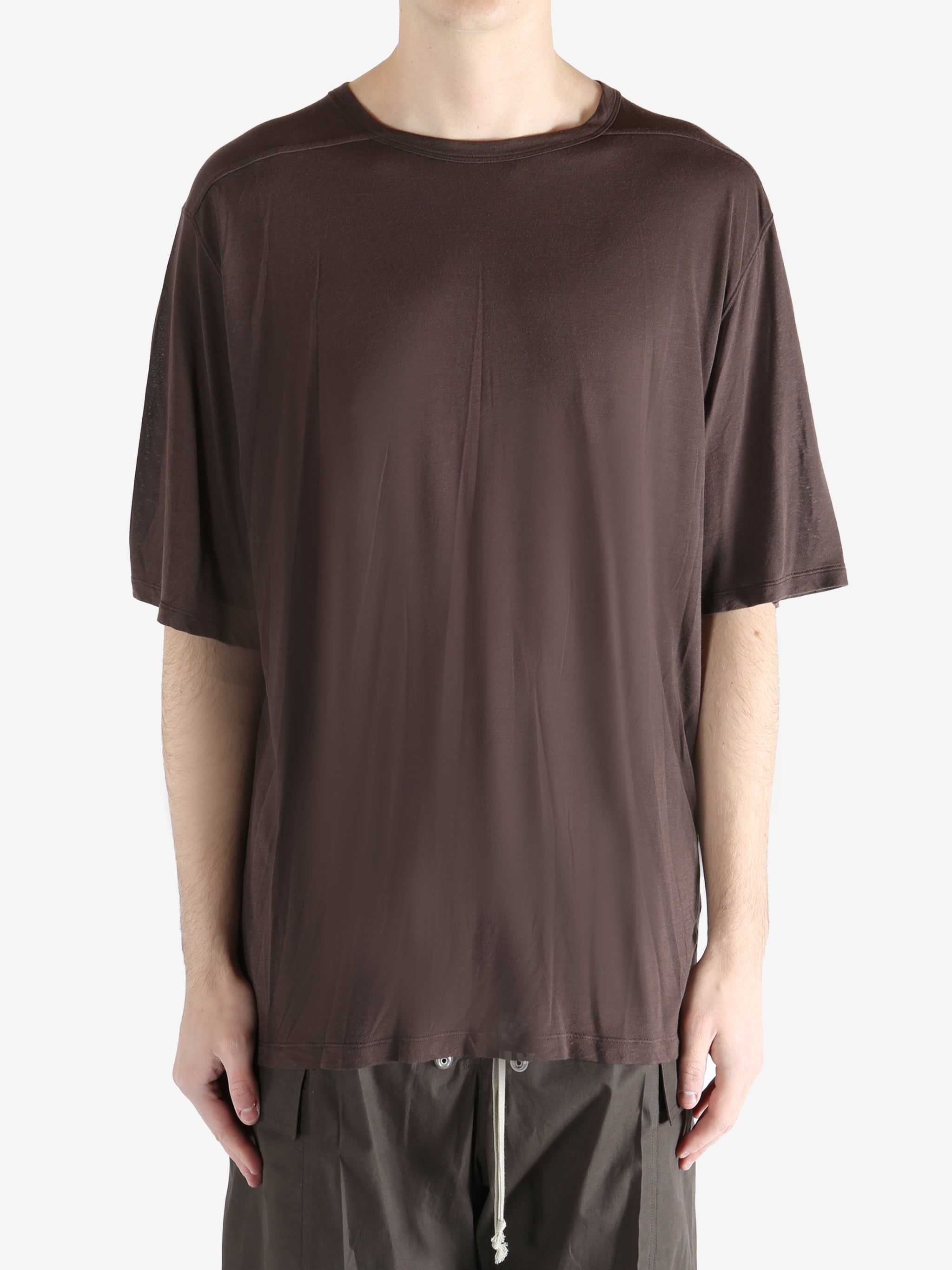 brown t-shirt worn by a person, showing the t-shirt fit